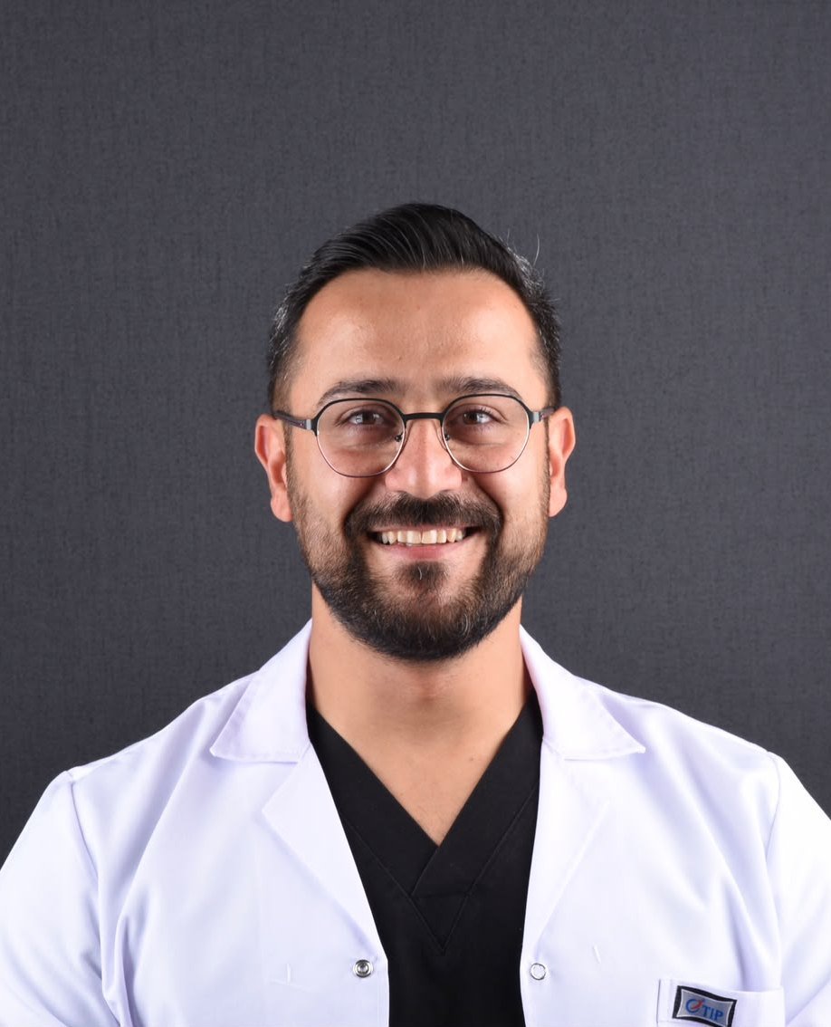 Bilal Turgut, implant dentist at Clinova Dental in Ankara, in a white clinic coat.